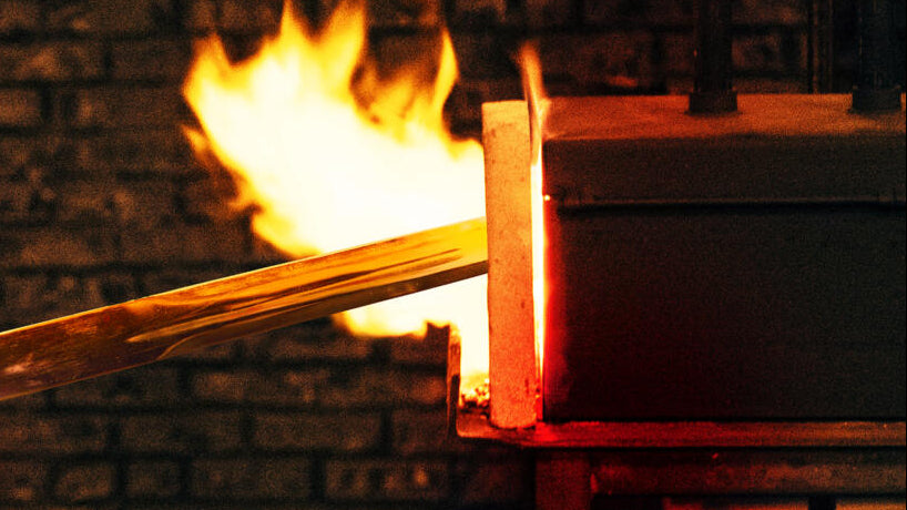 sword coming out of  firey forge